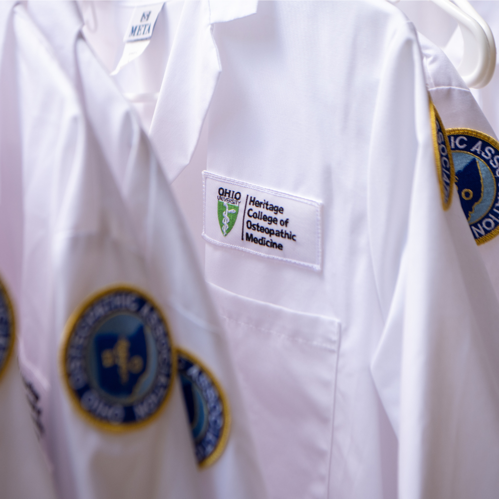 Doctoral white coat with Heritage College patch on the front