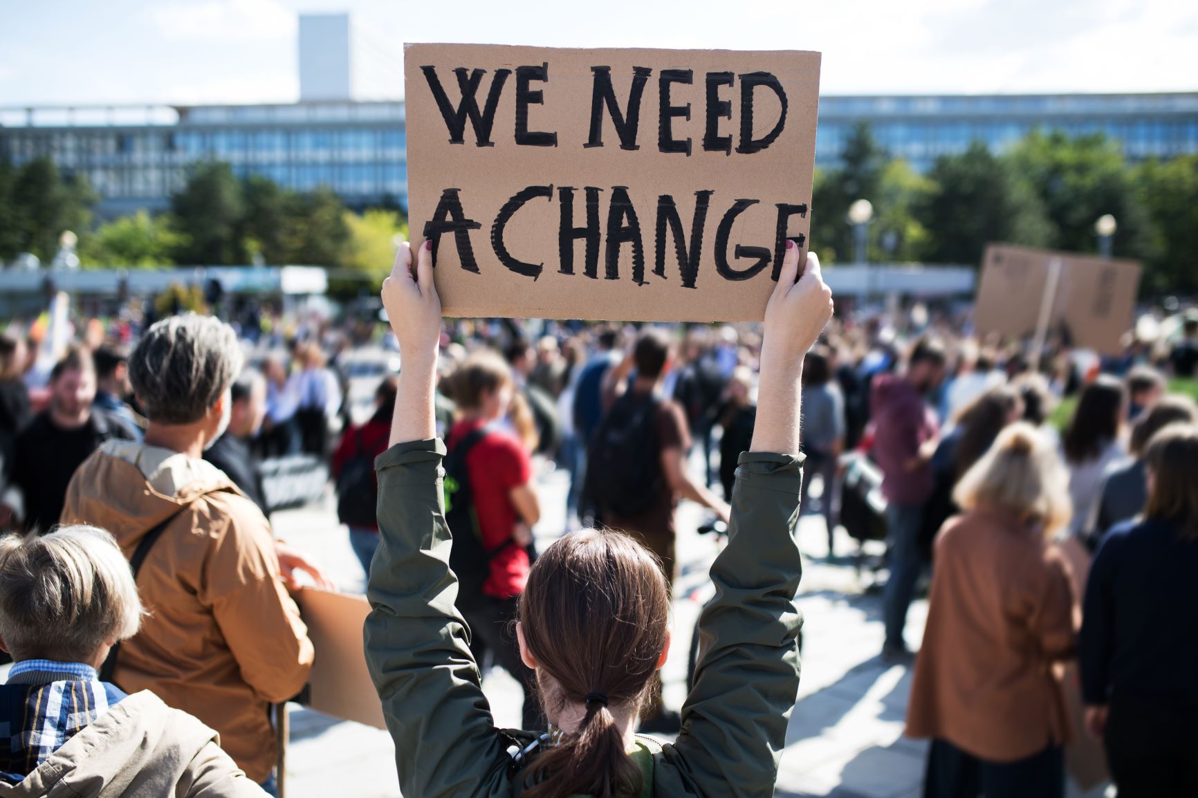 Sign at a protest reads "we need a change."