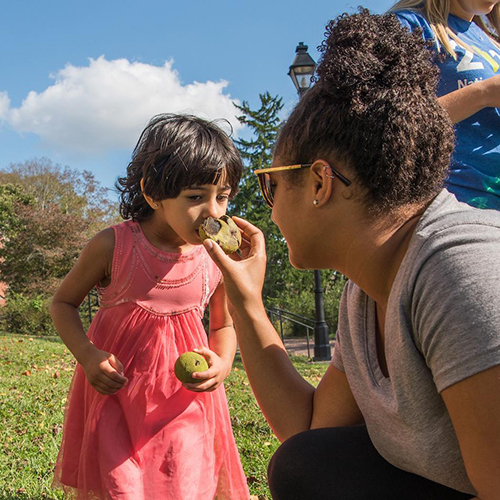 Ohio University students explore nature with a child