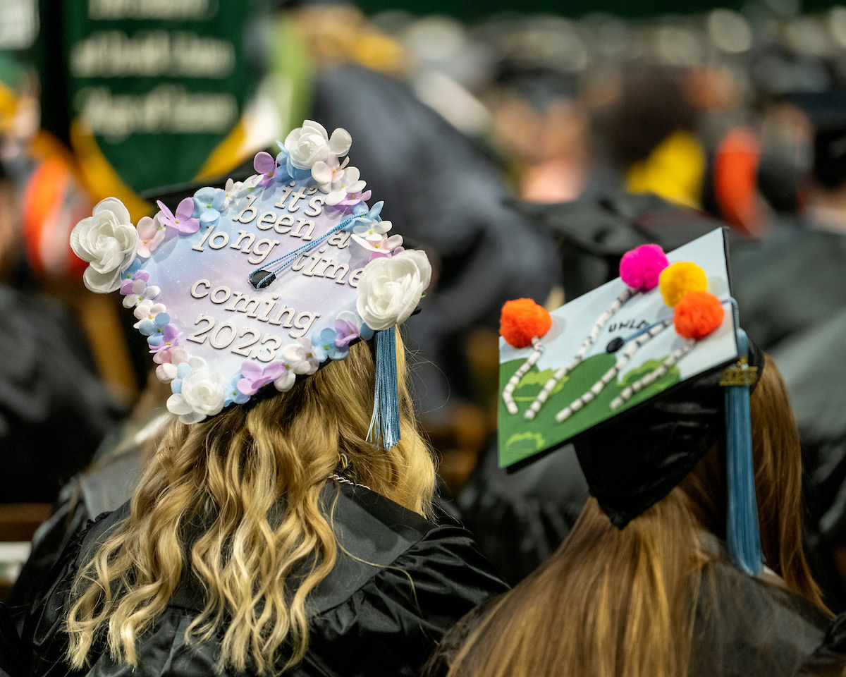 Graduating students show off their mortarboards at Fall Commencement