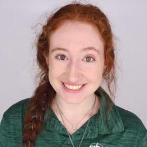 Julia in a dark green Bobcat Student Orientation shirt, smiling at the camera.