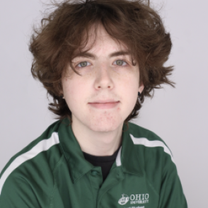 Nate in a dark green Bobcat Student Orientation shirt, smiling at the camera.