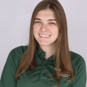 Ilana in a dark green Bobcat Student Orientation shirt, smiling at the camera.