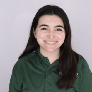 Megan in a dark green Bobcat Student Orientation shirt, smiling at the camera.