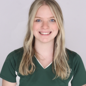 Ashley in a dark green Bobcat Student Orientation shirt, smiling at the camera.
