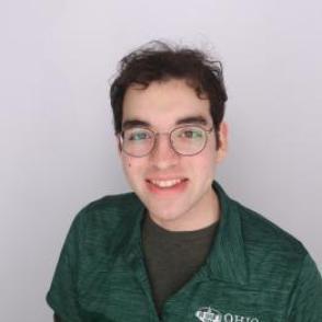 Vishal in a dark green Bobcat Student Orientation shirt, smiling at the camera.