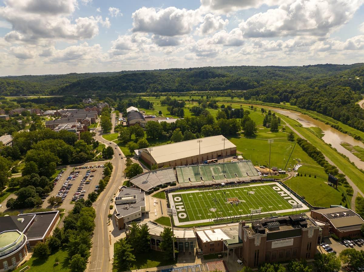Aerial view of Ohio University's football stadium, surrounded by rolling hills