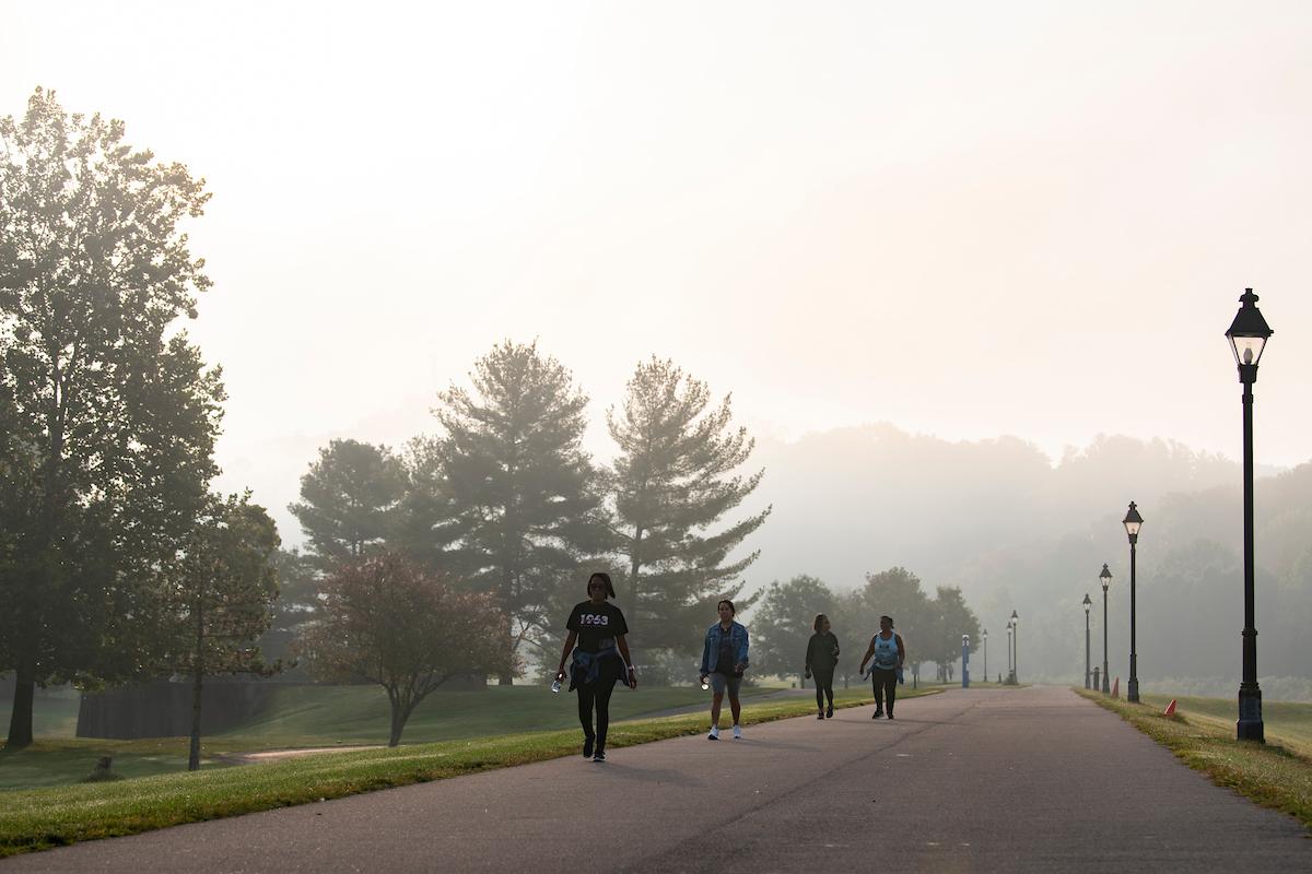 Ohio University alumni walk on a foggy bike path during Black Alumni Reunion