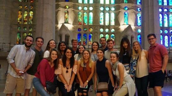 Business students pose in an international building