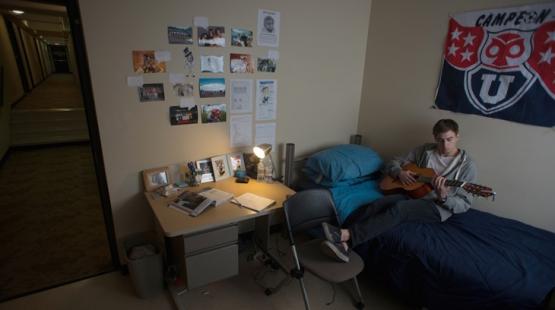 Ohio University student plays guitar in his dorm room