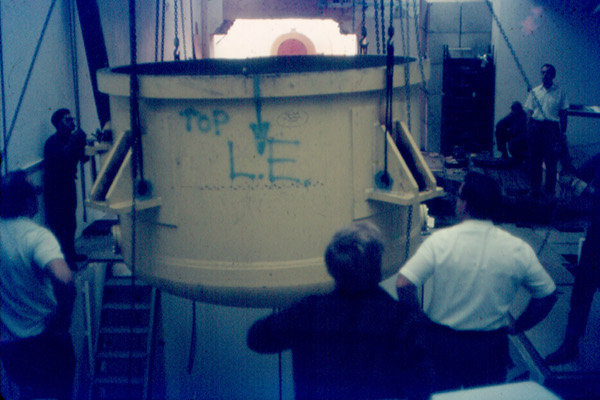 Lowering the bottom of the tank -- the base of the "T" -- into position. 