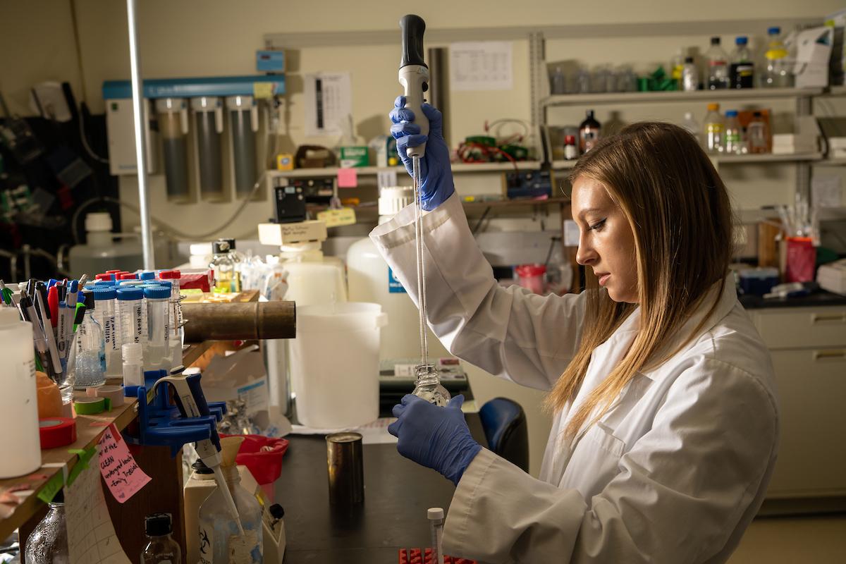 Emily Marino, a biological sciences student, uses scientific equipment in the Ronan Carroll Lab