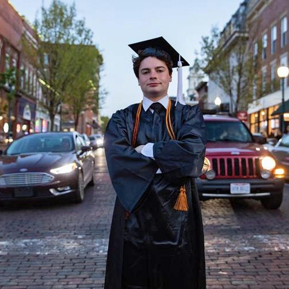 OHIO economics and political science graduate Matt Geiger stands on Court Street in Athens, Ohio.