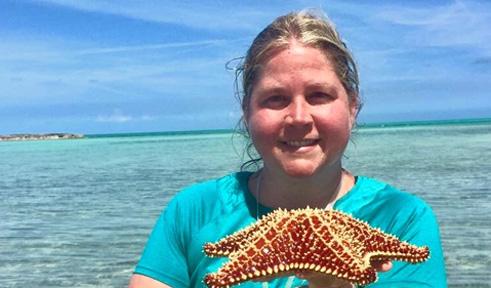 Karen Mammone, portrait taken outside with a starfish