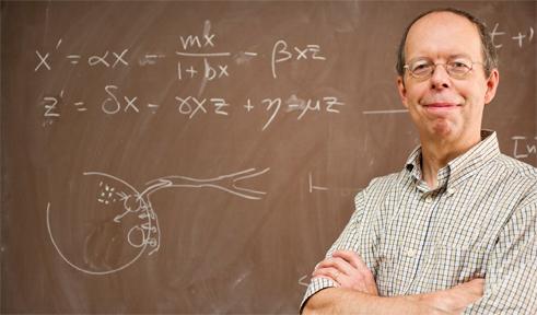 Todd Young, portrait in front of a chalkboard