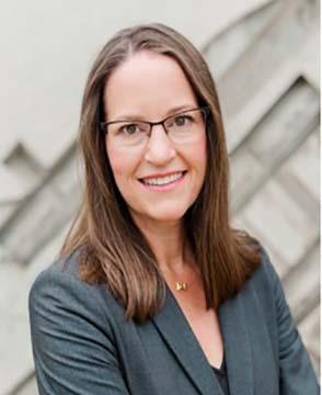 Headshot of a smiling Marci Shepard in a gray suit jacket