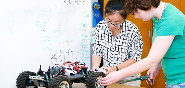 two students working on a remote control car