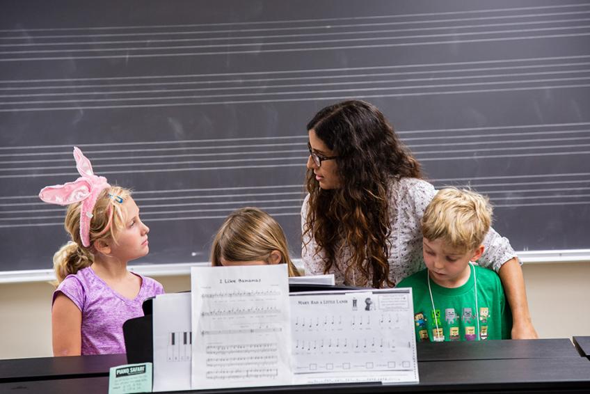 ACMS Piano teacher with children