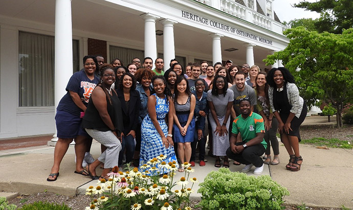 A group of pre-med students pose in front of Irvine Hall