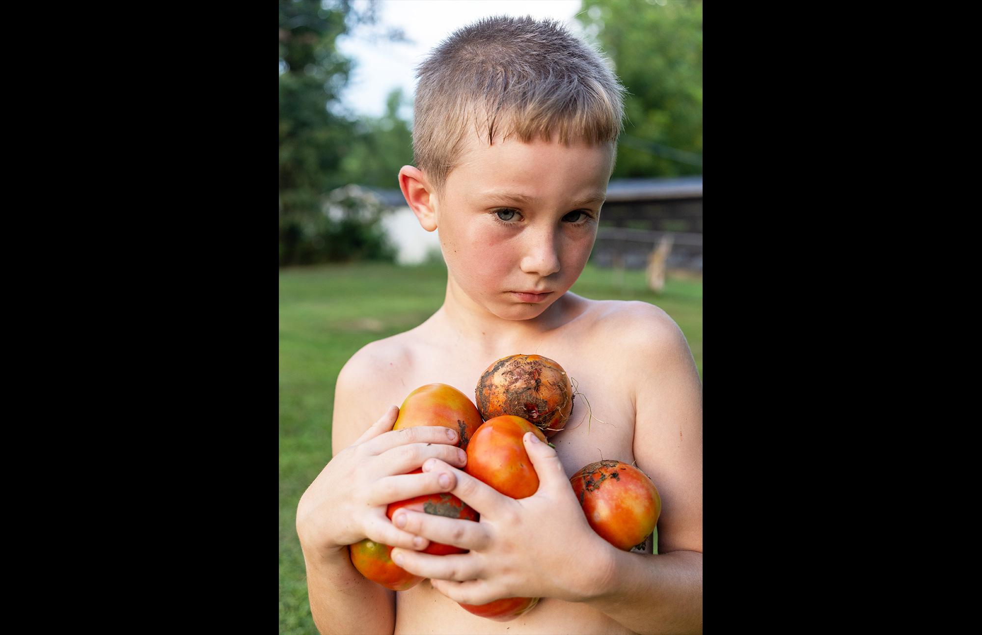 boy holding apples