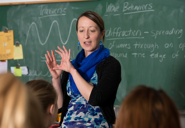 Instructor speaking to class and gesturing with hands as they talk