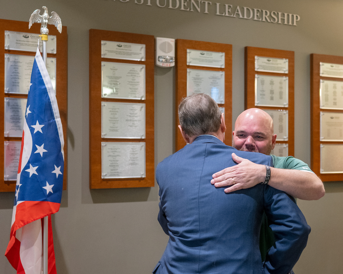 A veteran staff member congratulating a veteran