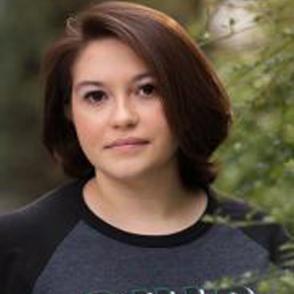 Isabel Alvarez looks at the camera, a neutral expression on her face. She is wearing a dark gray Ohio University shirt.