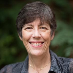 Dr. Jellison in a black collared shirt with white dots on it. 