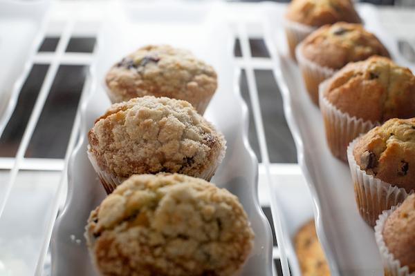 Photo of neatly arranged muffins in a case from Front Room Coffeehouse