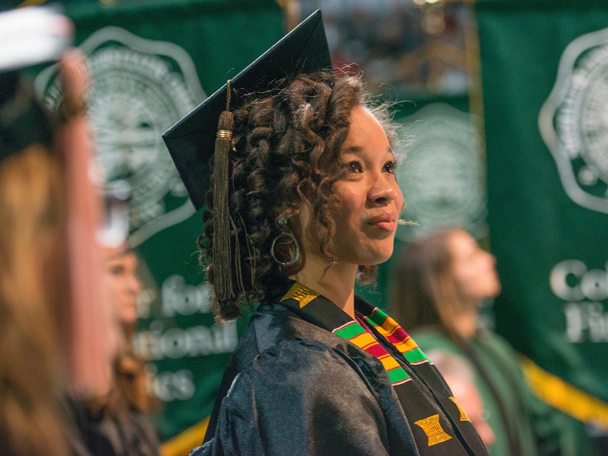 Student wearing cap and gown at Ohio University graduation ceremony
