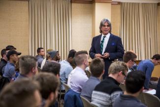 John McNellis speaks to a group of students