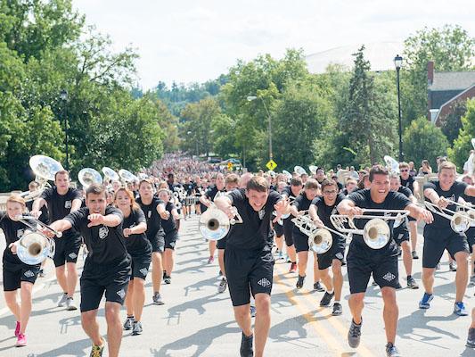 The Marching 110 lead a procession up Richland Ave following the First Year Student Convocation.