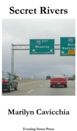 Cars on highway with signs overhead indicating 70 East towards Wheeling.