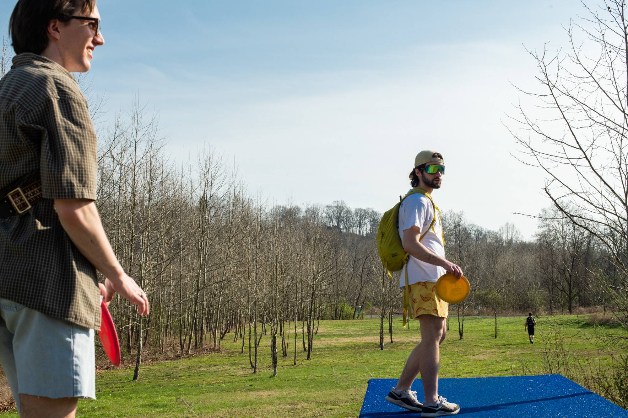 Ohio University students enjoy the spring weather with a round of frisbee golf along the Hockhocking-Adena Bikeway.