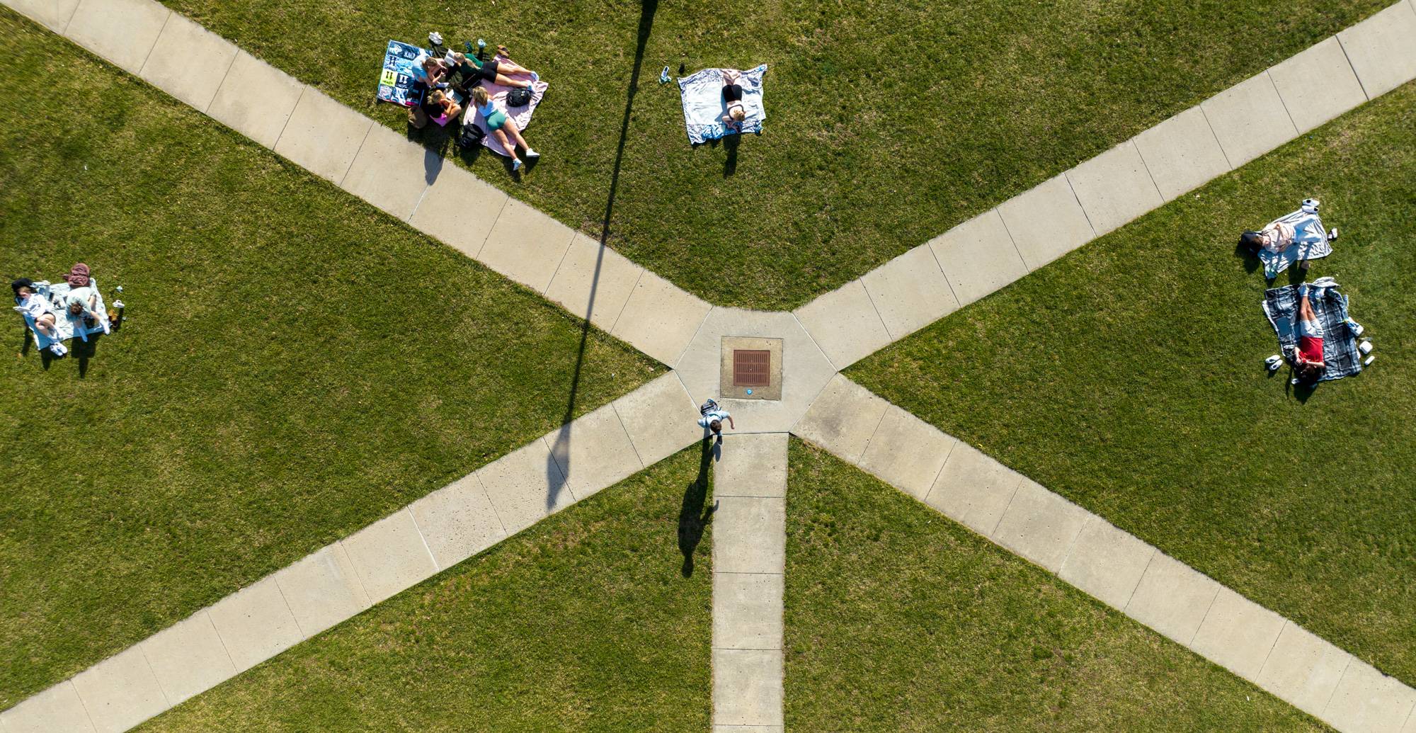 Students enjoy the warm weather on West Green.