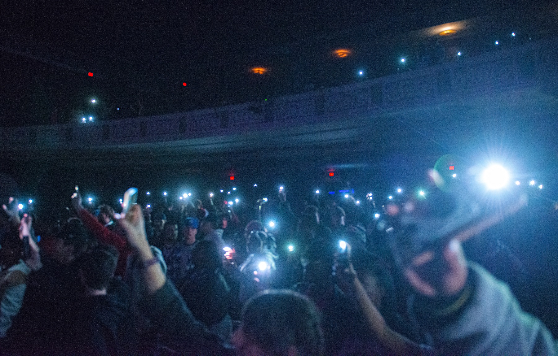 Audience members hold up their phones during a concert in Templeton-Blackburn Alumni Memorial Auditorium