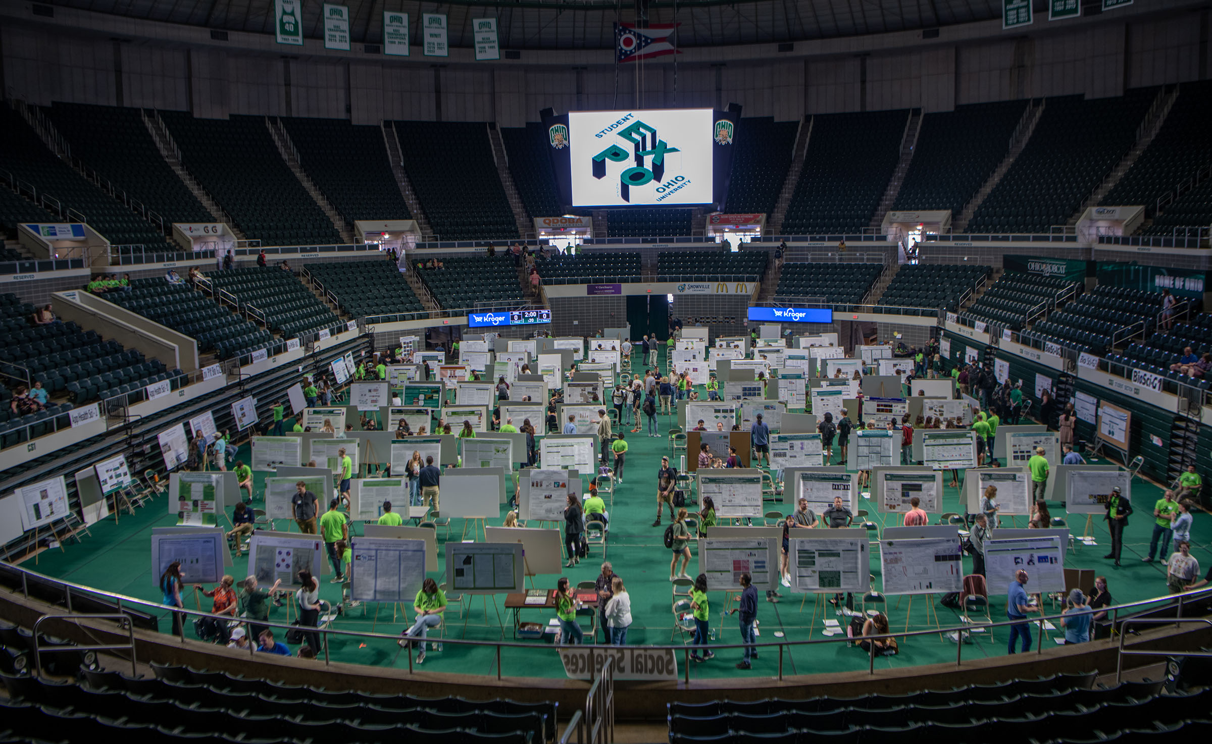 a wide view of student presentations displayed on the center floor of Ohio University's Convocation Center