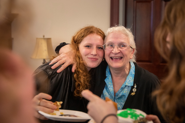 Two people embrace and smile at the camera