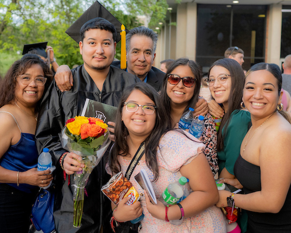 Family gather around a recent Ohio University Lancaster graduate.