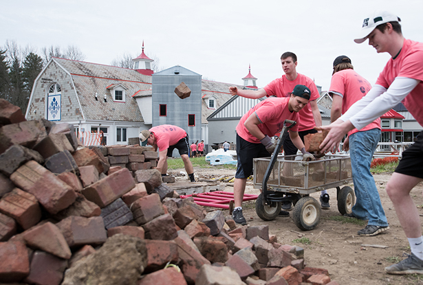 Volunteers clean up bricks located behind the Dairy Barn Arts Center.