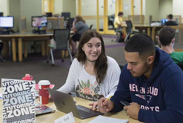 Eva Bugg, a student studying health services administration, tutors Anthony Imondi, a student majoring in sports management, in the Academic Achievement Center in Alden Library.