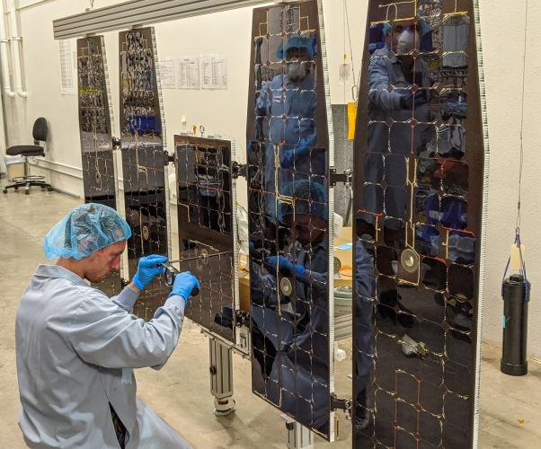 Tanner Wick, BSME ’19, is shown working on the solar array for NASA’a IXPE.