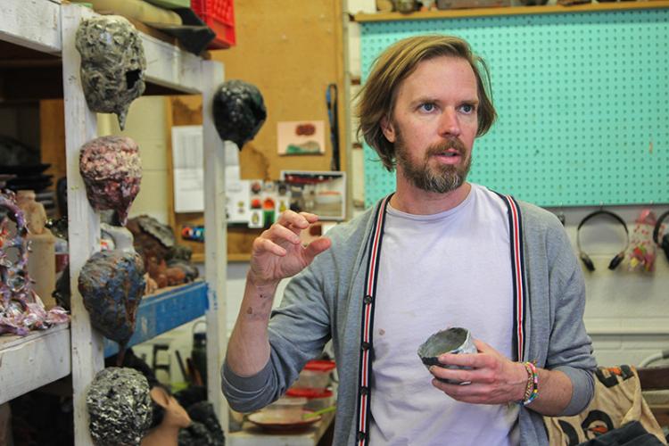 Artist gesturing in ceramics studio