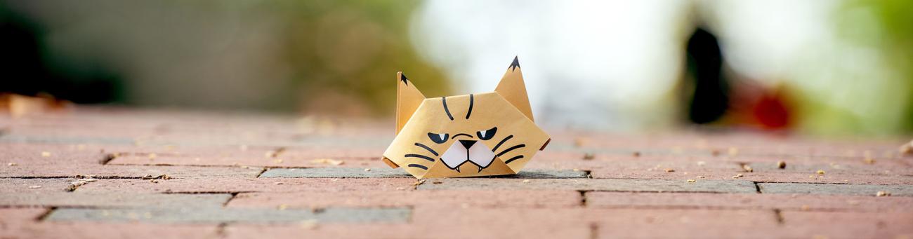 The origami bobcat poised on Athens bricks