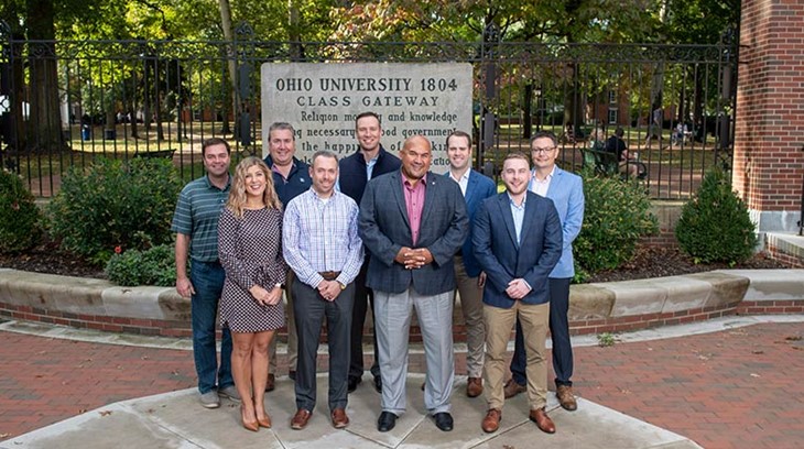 Members of the Society of Alumni and Friends pose in front of the Class Gateway