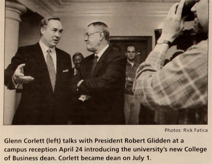 Clipping from a 1997 newspaper that says "Glenn Corlett (left) talks with President Robert Glidden at a campus reception April 24 introducing the university's new College of Business dean. Corlett became dean on July 1."