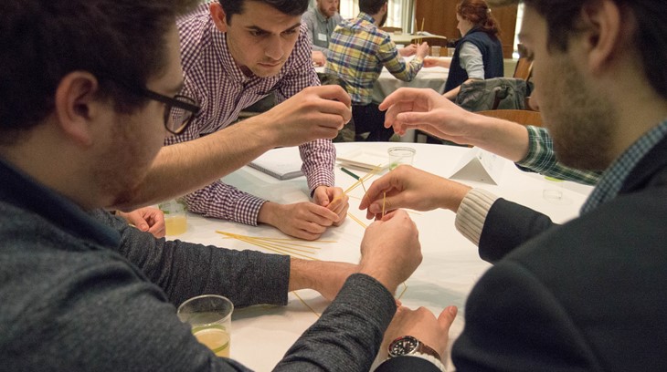 Business students work on a group activity at a table together