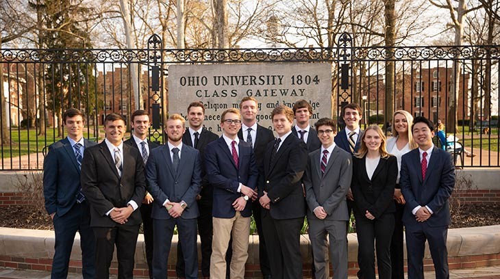 Members of the Derivatives Management group in the College of Business pose in front of the Class Gateway