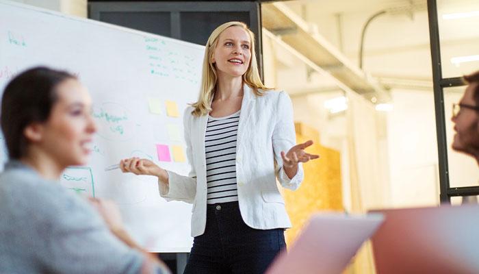 Female Marketing Director discussing strategy with team members.