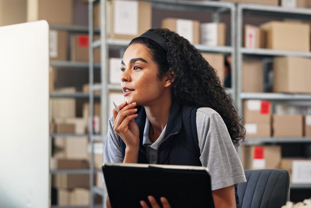 Supply chain manager reviewing a computer for inventory